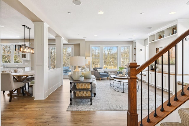 21360 Christmas Ln, Shorewood, MN 55331 - living area featuring recessed lighting, decorative columns, wood finished floors, and stairs
