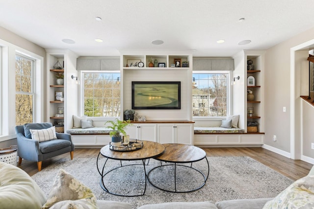21360 Christmas Ln, Shorewood, MN 55331 - living area with light wood finished floors, built in shelves, and a healthy amount of sunlight