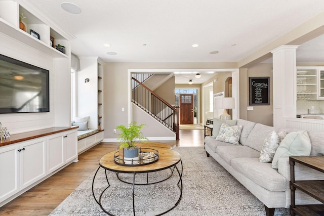 21360 Christmas Ln, Shorewood, MN 55331 - living room with decorative columns, recessed lighting, stairway, and light wood-type flooring