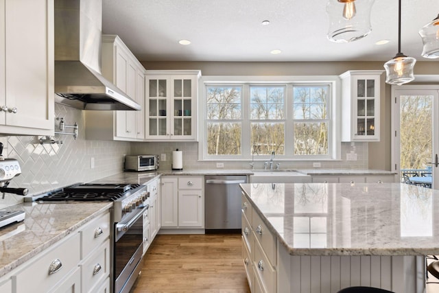 21360 Christmas Ln, Shorewood, MN 55331 - kitchen with a sink, wall chimney range hood, white cabinetry, and stainless steel appliances