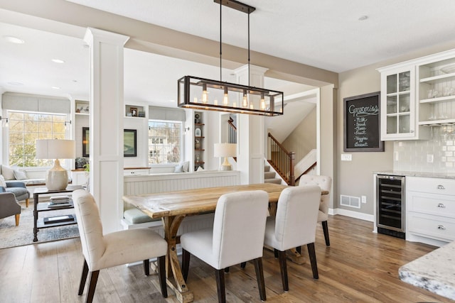 21360 Christmas Ln, Shorewood, MN 55331 - dining area featuring visible vents, a dry bar, wood finished floors, stairs, and beverage cooler