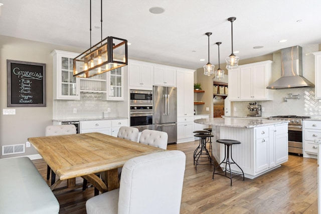21360 Christmas Ln, Shorewood, MN 55331 - kitchen featuring visible vents, open shelves, wall chimney range hood, high end appliances, and backsplash