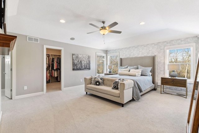 21360 Christmas Ln, Shorewood, MN 55331 - bedroom with baseboards, light carpet, a spacious closet, a ceiling fan, and visible vents