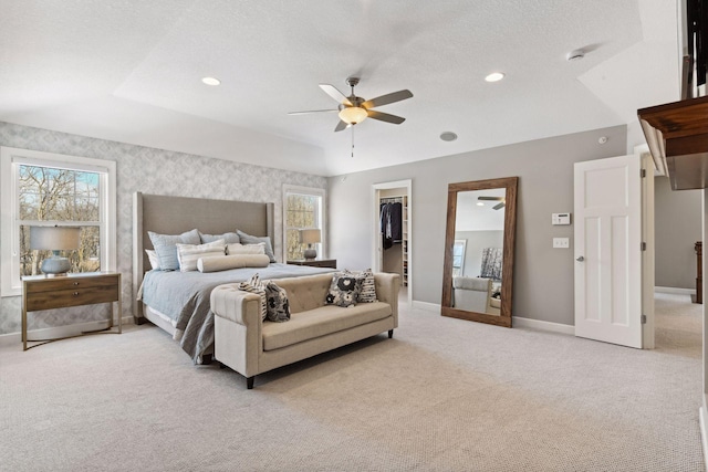 21360 Christmas Ln, Shorewood, MN 55331 - bedroom with a walk in closet, baseboards, multiple windows, and light carpet