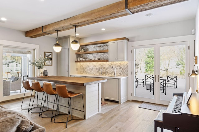 21360 Christmas Ln, Shorewood, MN 55331 - bar featuring french doors, decorative backsplash, light wood finished floors, and beam ceiling