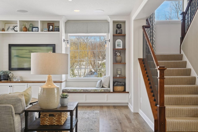21360 Christmas Ln, Shorewood, MN 55331 - sitting room featuring light wood-style floors, built in features, and stairway
