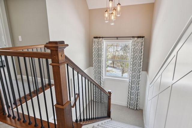 21360 Christmas Ln, Shorewood, MN 55331 - stairway with a wainscoted wall, an inviting chandelier, and carpet