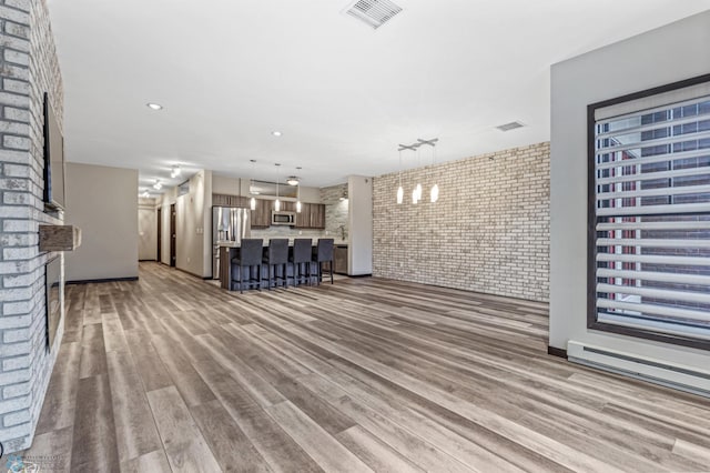 unfurnished living room with light hardwood / wood-style flooring