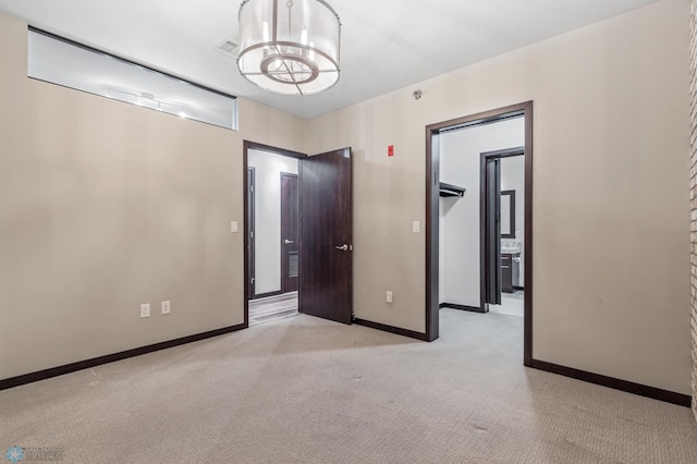 interior space featuring light carpet and an inviting chandelier