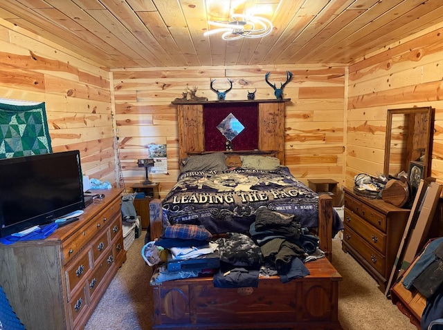 bedroom featuring dark colored carpet, wood walls, and wooden ceiling