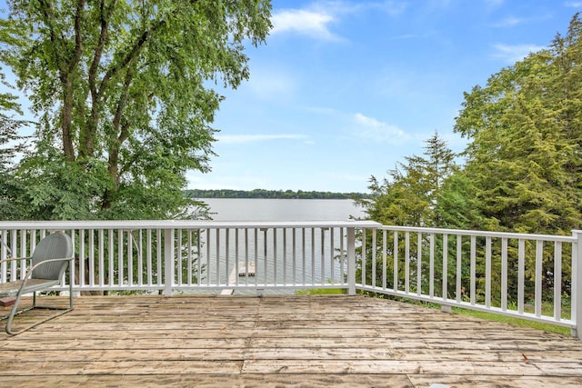 wooden terrace featuring a water view