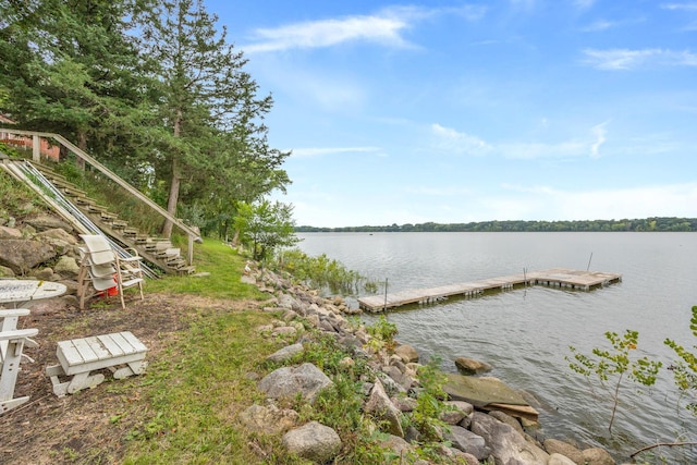 dock area with stairway and a water view