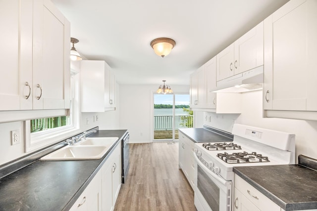 kitchen with white range with gas stovetop, white cabinets, and under cabinet range hood