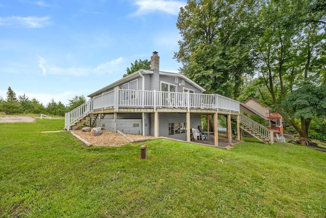 back of house with a deck, a chimney, a yard, and stairway