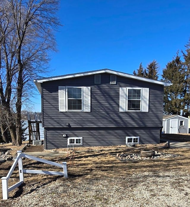 view of side of home with a shed and stairs