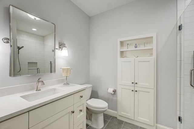 bathroom with tile patterned flooring, a stall shower, toilet, and vanity