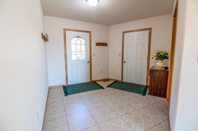 foyer with a textured ceiling