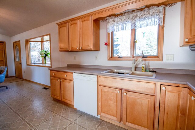 kitchen with dishwasher, light tile patterned flooring, and sink