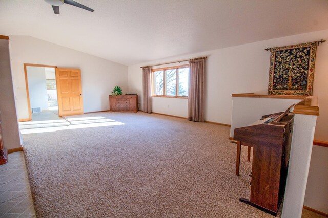 spare room featuring carpet, ceiling fan, and lofted ceiling