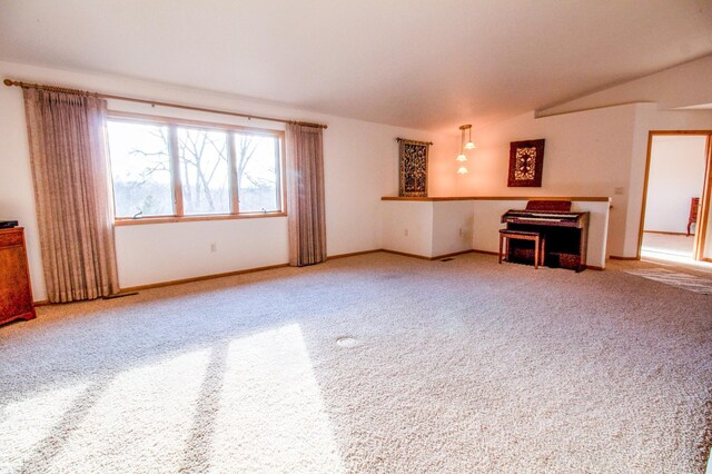 unfurnished living room with carpet and lofted ceiling