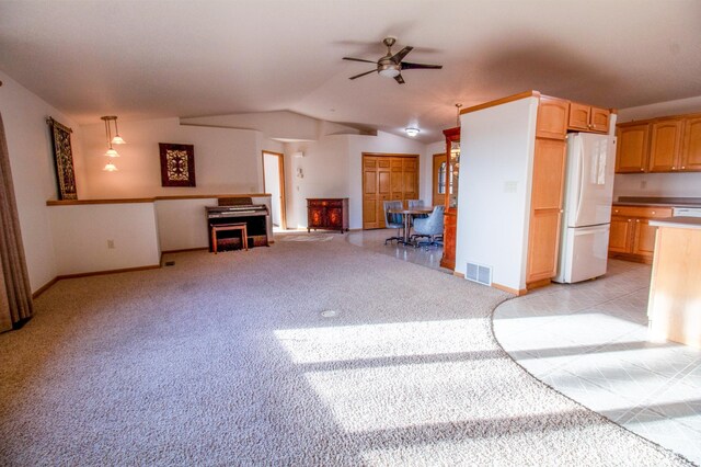 kitchen featuring ceiling fan, white fridge, light colored carpet, lofted ceiling, and decorative light fixtures