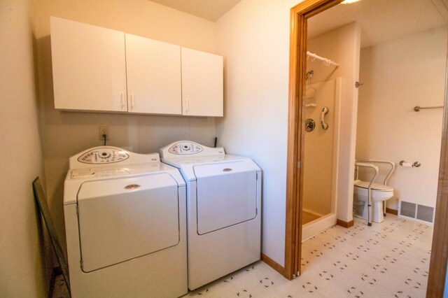 laundry room with cabinets and separate washer and dryer