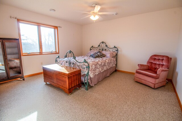 bedroom with ceiling fan and light colored carpet