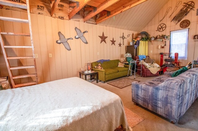 bedroom featuring wood walls, lofted ceiling, and concrete floors