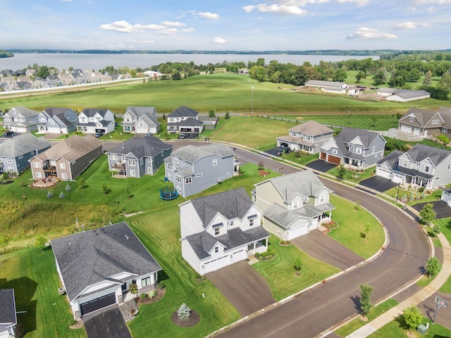 drone / aerial view with a water view and a residential view