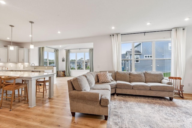 living room featuring light wood finished floors and recessed lighting