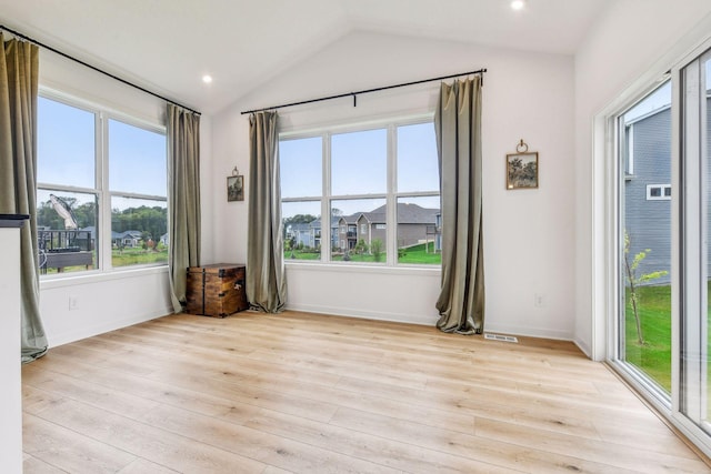 unfurnished room featuring light wood-type flooring, lofted ceiling, a wealth of natural light, and recessed lighting