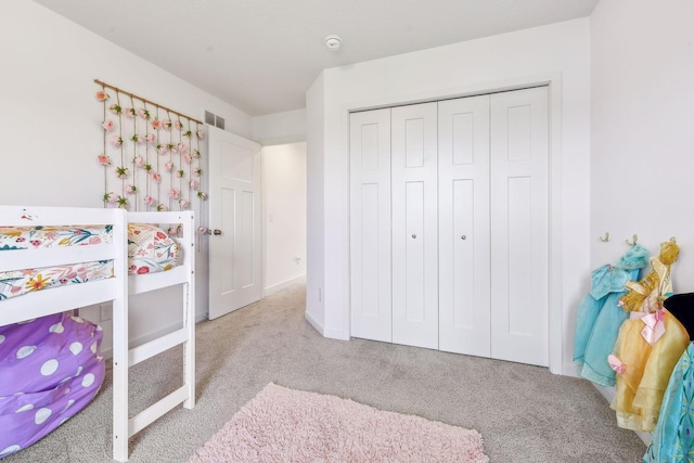 bedroom with carpet floors, a closet, and visible vents