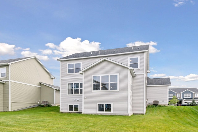 back of house with a lawn and central air condition unit