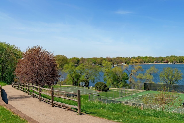 view of community with a water view and fence