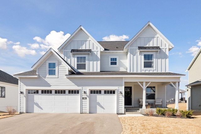 view of front facade featuring driveway, an attached garage, a porch, and board and batten siding