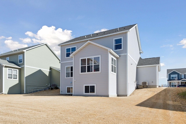 rear view of property featuring central AC unit