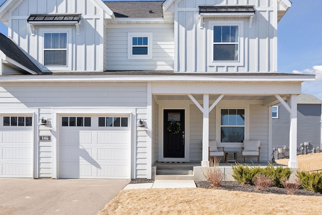 modern farmhouse style home featuring driveway, a garage, roof with shingles, covered porch, and board and batten siding