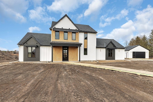 modern farmhouse style home with a garage and an outdoor structure