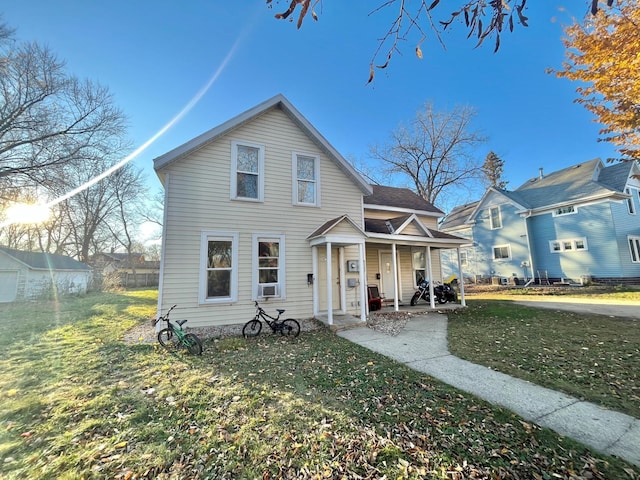 view of front of home with covered porch and a front yard