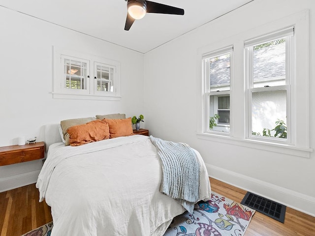 bedroom with wood-type flooring and ceiling fan