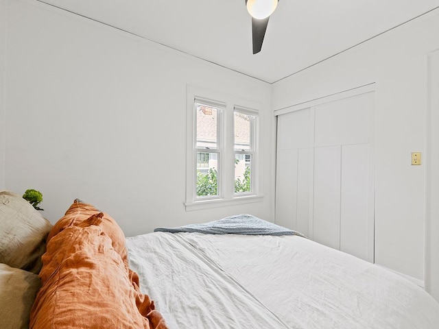 bedroom featuring ceiling fan and a closet