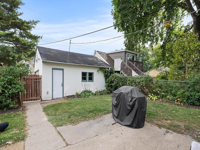 rear view of property with a yard