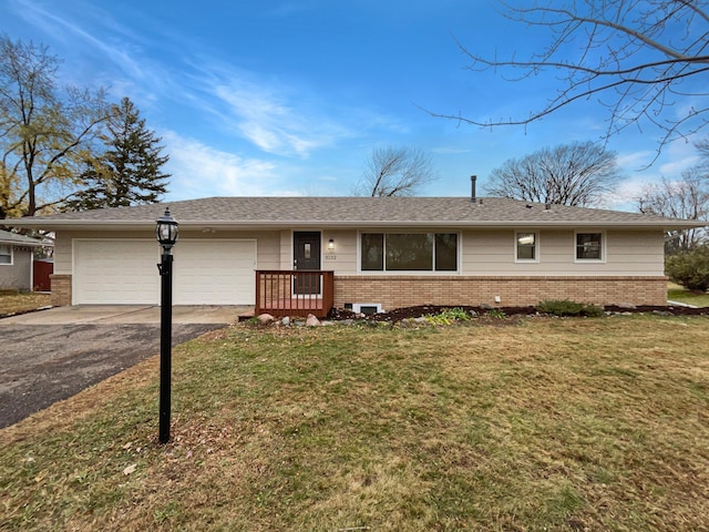 single story home featuring a front yard and a garage