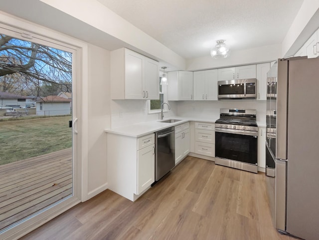 kitchen featuring white cabinetry, sink, and stainless steel appliances