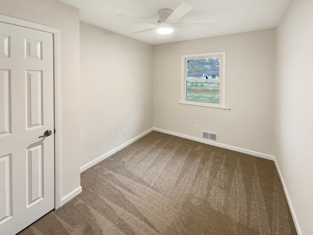 spare room featuring carpet flooring and ceiling fan