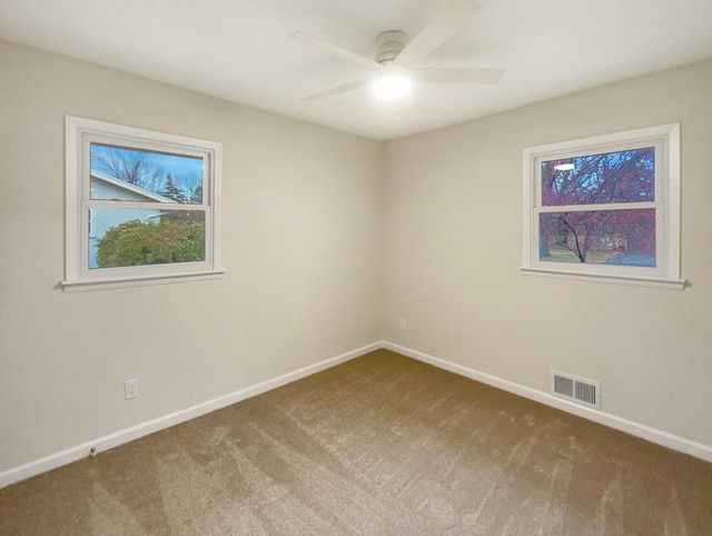 empty room featuring carpet and ceiling fan