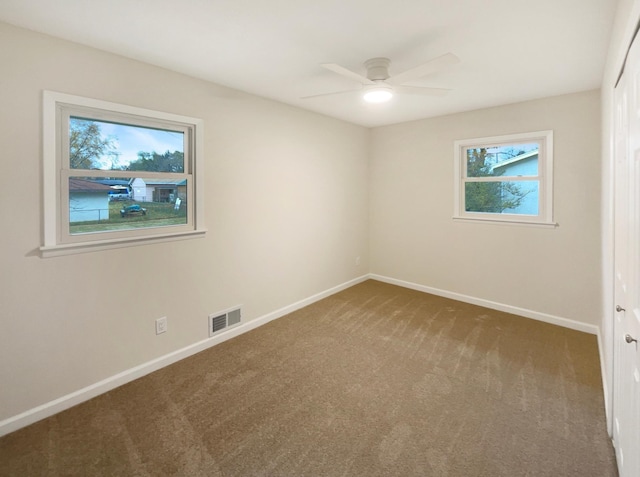 carpeted empty room featuring ceiling fan