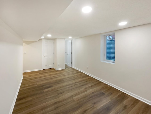 basement with dark hardwood / wood-style flooring