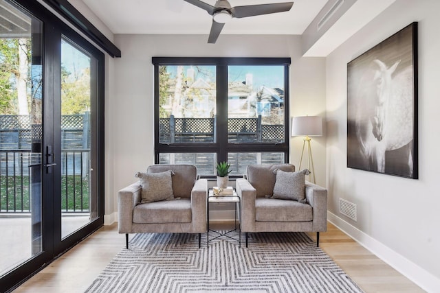 sitting room featuring ceiling fan and light wood-type flooring