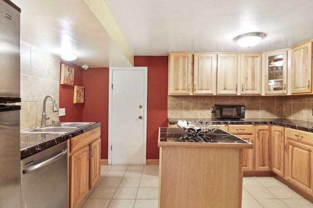 kitchen featuring a center island, light brown cabinets, sink, light tile patterned floors, and appliances with stainless steel finishes